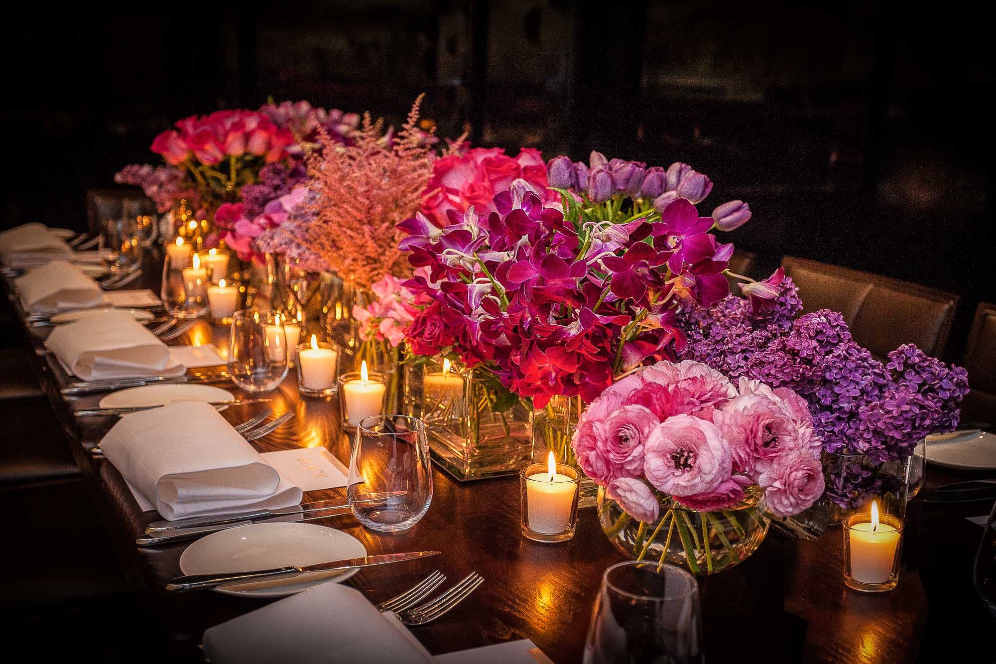 A beautiful Susan Avery table setting with bright flowers and candles.