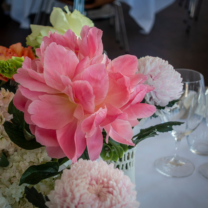 Close-up of a pink flower among the Catalina wedding table arrangements