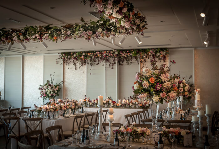 A beautiful, "shabby chic" and vintage wedding at Zest, Royal Motor Yacht Club in Sydney Australia included roses and seasonal foliages plus a 5x5 metre hanging arrangement. This installation was designed by Susan, and made, delivered, and installed by the Susan Avery team.