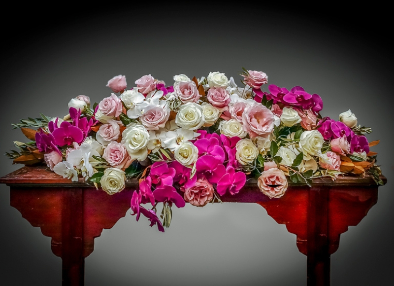 Casket cover — Soft colourful featuring roses and orchids in pale pink, magenta, whites and cream. Minimal foliage